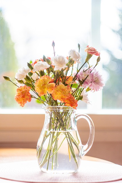 Delicate flower arrangement in a clear glass vase.